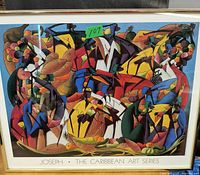 Framed colorful print titled 'Joseph The Caribbean Art Series' featuring an abstract Caribbean scene with stylized figures and tropical motifs.