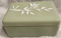 Top and side views of the green Lenox ceramic rectangular trinket box showing embossed white vine and leaf design on the lid.