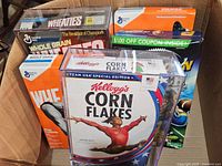 Five new sealed vintage cereal boxes including Kellogg's Corn Flakes and multiple Wheaties boxes