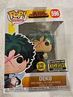 Photo of the My Hero Academia Deku Funko Pop vinyl figure in its original box, showing front of the box with branding and exclusive limited edition stickers.