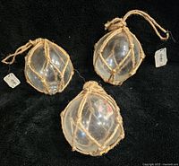 Set of 3 clear glass globes tied in natural fiber netting for nautical style decor, all new with tags.