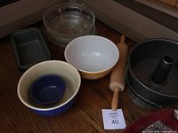 Full view of all items in the baking lot showing bowls, rolling pin, cake pan, bread pans, glass pie plates
