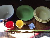 Dishware and drinkware arranged to show all items including mixing bowls, mugs, and plate.