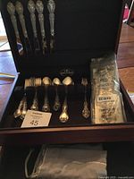 Reed & Barton wooden chest open showing flatware set and sealed replacement piece