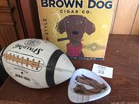 Brown Dog Cigar Co. woven decorative piece with brown dog illustration on yellow background