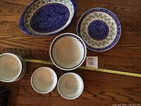 Overview of all items arranged showing oblong serving bowl, dinner plate, and cereal bowls.