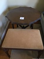 Top and side view of the wooden side table and tan velvet padded bench, showing surface condition and carved legs of bench