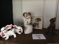 Full view of the lot items including the three figurines and puppy salt and pepper shakers