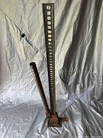 Full view of the 48-inch heavy-duty farm jack showing the long perforated bar with handle and base plate on a white background.