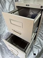 Front angle showing two open drawers with dividers inside and metal handles, label holders on drawer fronts