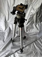 Full view of the Manfrotto Art 290 tripod showing aluminum legs, mounting head, and adjustment knobs.