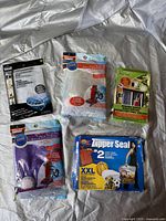 Photo showing five different new unopened plastic storage and vacuum seal bags in original packaging.