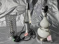 The lot showing all three lamps: lava lamp, cylindrical crystal accent lamp, and white ceramic lamp base.