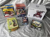 Overall collection of boxed toys including K'NEX, Totoro, Marvel figure, K5 Aroma Star, Rookie puzzle, and airplane model kit.