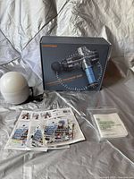 All items: percussion massage gun in box, white diffuser, designer face masks, luxury facial flannel in packaging