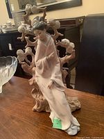 Front view of figurine against wood table