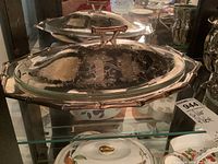 Photo of large covered serving dish with handles and lid with handle, silver plate with floral motifs