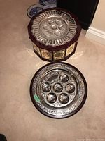Top and side view showing overall design of the 4-level Seder plate with silver serving plates and wooden frame with etched panels.