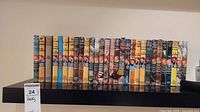 Full view of all 28 hardcover Hardy Boys books placed side by side showing colorful spines and titles, dust covers show wear.