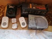 Photo showing a variety of rodent control devices including an electronic zapper, snap traps, ultrasonic pest repellers, and sensor devices.