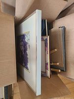 Box with larger picture frames and backing with easels inside.