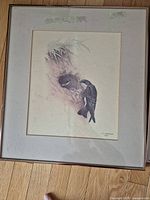 Framed bird print by J.F. Lansdowne showing bird at nest with some damage to mat around image.