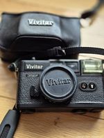 Vivitar 35EF camera with lens cap and black carrying case, front view