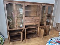 Full view of the 3-piece china cabinet showing outer glass door cabinets and central open shelving and storage section