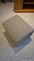 Fabric footstool, closed view showing pattern and upholstery