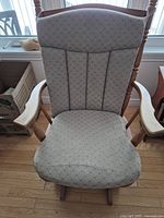 Top-down front view showing upholstered seat and backrest with wood armrests and legs.