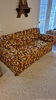 Front-angle view of floral upholstered pull-out couch