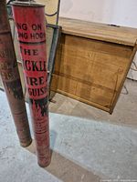 Close view focusing more on the red vibrant Bickle fire extinguisher with partial view of the worn extinguisher behind it.