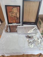 Serving trays and assorted cutlery arrangement on table showing trays and various cutlery pieces