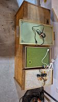 Full view of three vintage glass hotplates on wooden surface showing cords and colors