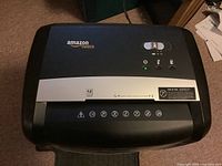Top view of Amazon Basics paper shredder showing control panel and branding.