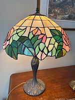 Front view of stained glass shade with rose and leaf motif