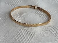 Bracelet laid in oval shape showing overall design and finish