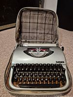 Vintage Eaton's typewriter inside its original carrying case, shown open to display keyboard and type mechanism.