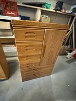 Full view of the dresser showing six drawers and cabinet door with wood grain finish.