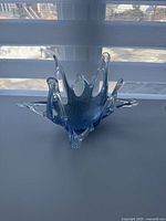 Full view of the Murano art glass bowl showing its spiked design and blue marbled interior.