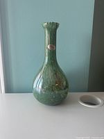 Full front view of the green Murano glass vase showing shape and color.