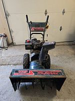 Front view of the Murray gas snowblower showing auger housing, brand, and power rating.
