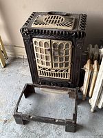 front view of cast iron wood stove on detached base