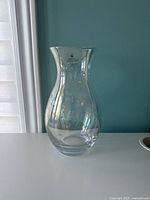 Front view of the clear hand cut glass vase with label visible.