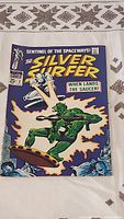 Front cover of The Silver Surfer #2 comic book showing the Silver Surfer and green alien on a flying saucer with title and Marvel Comics branding.