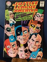 Front cover of Justice League of America Comic Book No. 61 showing colorful illustration of Justice League characters' faces and story title.