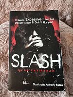Front cover of the Slash autobiography book showing the title, image of Slash smoking a cigarette, and subtitle.