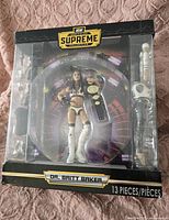 Front view of AEW Dr. Britt Baker wrestling figure packaged with accessories