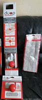 Photo of brand new Duop mop set components still in packaging, showing mop handle with quick ball attach, large cleaning pad and holder, small pad holder with pad, and packaged multi-purpose pads.