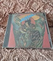 Front cover of the Dokken Beast From The East CD showing illustrated warrior and dragon with album title.